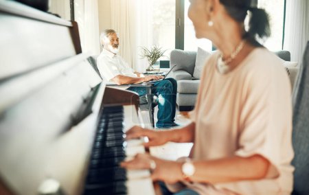 Photo for Senior woman playing piano for music in living room for bonding, entertainment or having fun. Happy, smile and elderly Asian female person with husband in retirement enjoying keyboard at modern home - Royalty Free Image