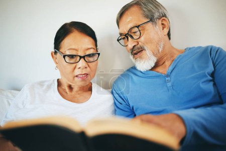 Photo for Bible, home or senior couple reading book for prayer, support or hope in bed to worship together. Education, Asian man or mature woman learning or studying God for grace in religion with love or care. - Royalty Free Image