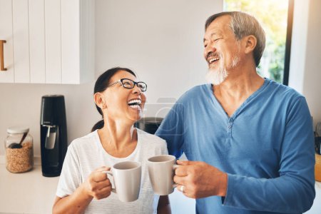 Photo for Coffee, happy and senior couple in kitchen with hot beverage, tea and caffeine for breakfast. Marriage, retirement and Asian man and woman in home laugh for bonding, relationship and commitment. - Royalty Free Image