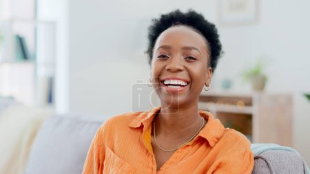 Photo for Portrait, funny and a black woman laughing on a sofa in the living room of her home to relax on the weekend. Face, smile and comedy with a happy young person in her apartment to joke for humor. - Royalty Free Image