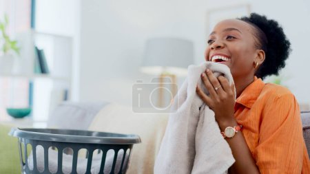 Photo for Clean, smell and happy woman with laundry in home or basket with clothes, linen or maid spring cleaning in apartment. Black person, washing or clothing with detergent or cleaner scent on fresh fabric. - Royalty Free Image