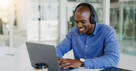 Photo for Businessman, laptop and headset by listening to music, podcast or radio for wellness while working. Black person, consultant or employee for typing, report or internet by email for message to client. - Royalty Free Image
