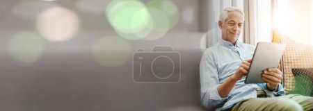 Photo for Senior man, tablet and sofa for internet, social media and asset management research at home with banner mockup. Happy elderly person scroll or typing on digital technology for pension FAQ in overlay. - Royalty Free Image