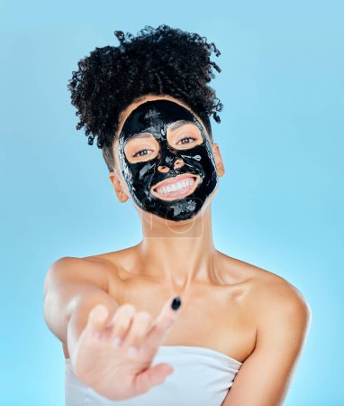 Photo for Skincare, face mask and portrait of woman with finger for facial treatment, anti aging or wellness. Beauty, studio and happy person apply products for health, cosmetics or grooming on blue background. - Royalty Free Image