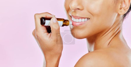 Photo for Closeup, woman and beauty with lip balm in studio with mockup for treatment on pink background to hydrate. Female model, smile and cosmetic for dermatology with omega 3, vitamin c and hyaluronic acid. - Royalty Free Image