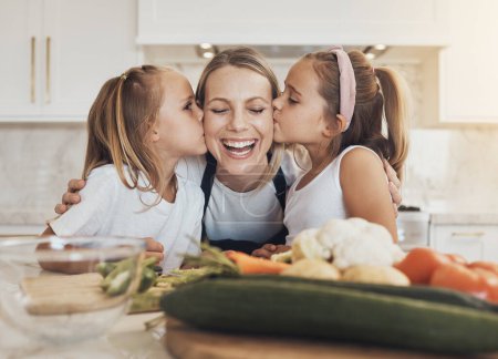 Photo for Home, cooking and mother with children, kissing and care with bonding, healthy food and weekend break. Family, mama or children with mom, kids and ingredients with a smile, kitchen or relax with love. - Royalty Free Image