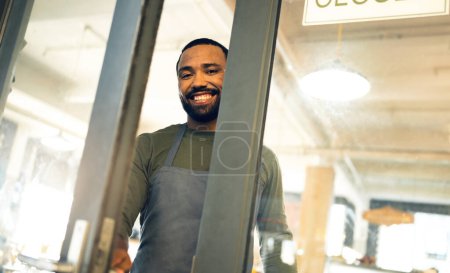 Photo for Happy, door and portrait of a man at a coffee shop to open a small business or welcome customer. Smile, work and a waiter or barista at the entrance of a cafe, restaurant or cafeteria for service. - Royalty Free Image