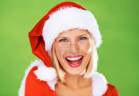 Photo for Woman, Christmas hat and celebration in studio for season holiday, vacation happiness or fun fashion. Female person, smile and portrait in red costume or green background, winter break joy or excited. - Royalty Free Image