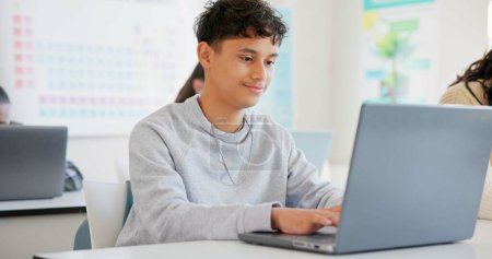 Photo for Man, student and laptop for school, elearning and studying or research in college or class. Teenager typing on computer for planning, classroom information and scholarship application or online FAQ. - Royalty Free Image