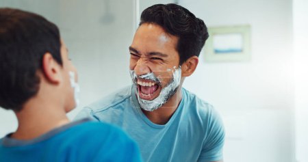 Photo for Shaving cream, child and father together in bathroom, family home or boy learning morning skincare, beauty and grooming routine. Funny, happy dad and son helping with foam, razor and skin care. - Royalty Free Image