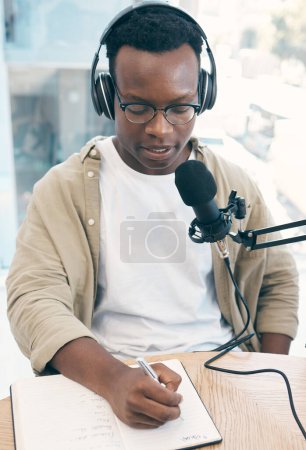 Photo for Radio, podcast and black man in office writing notes for advice, questions or feedback while live streaming. Speech, presenter and African male with broadcast announcement, news or hosting talk show. - Royalty Free Image