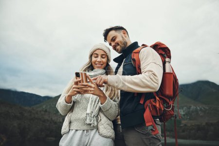 Photo for Couple, phone and travel in nature or mountains with hiking information, social media or check for direction on journey. Happy people trekking in backpack, mobile chat or search for outdoor location. - Royalty Free Image