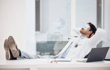 Photo for Man, doctor and sleeping with face mask in relax for done, completion or finished at hospital office. Tired male person, medical surgeon chilling on break, rest or asleep on work desk at clinic. - Royalty Free Image