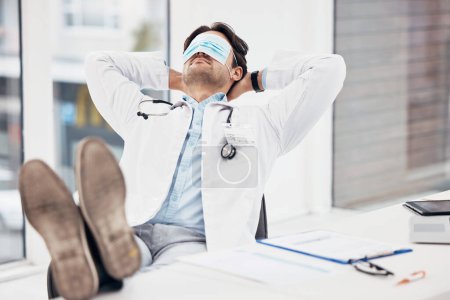 Photo for Man, doctor and sleeping with face mask on break or relax for done, completion or finished at hospital office. Tired male person or medical surgeon chilling for rest or asleep on work desk at clinic. - Royalty Free Image