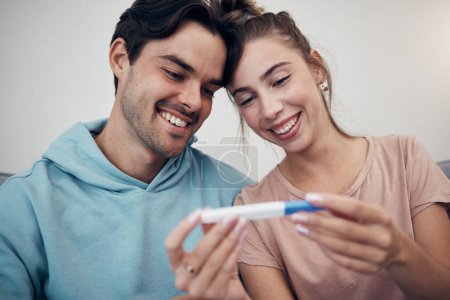 Photo for Pregnancy, test and smile of couple in home, reading good news or check positive results. Pregnant, stick and happy man and woman in living room excited for success, future maternity or ivf fertility. - Royalty Free Image