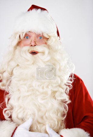 Photo for Santa claus, surprise and portrait in studio for Christmas celebration, season greeting or vacation joy. Male person, shock emoji face and red costume for holiday traditions, event or wow fun mockup. - Royalty Free Image