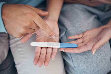 Photo for Hands, couple and closeup of pregnancy test, results and waiting for news together in home. Top view, kit and pregnant woman and man family planning for future maternity, ivf fertility and support. - Royalty Free Image