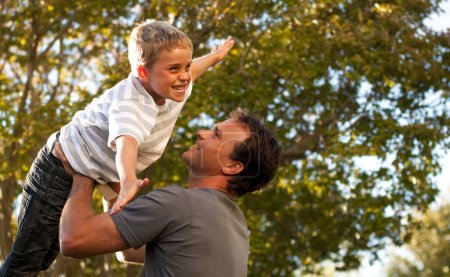 Photo for Dad, child and garden with airplane game, happy bonding and fun morning playing for father and son. Outdoor fun, love and playful energy, man holding boy in air and laughing in backyard together - Royalty Free Image