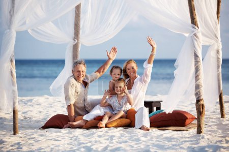 Photo for Portrait, wave and family with vacation, beach and relax with adventure, travel and tourism. Face, parents and mother with father, children and seaside holiday with gesture, tent and summer break. - Royalty Free Image