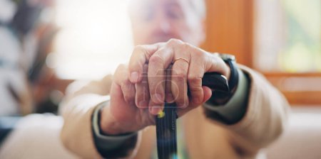 Photo for Walking stick, hands and senior man with a disability in home, apartment or retirement with support for injury. Elderly, closeup or person with wood cane to help balance or mobility with arthritis. - Royalty Free Image