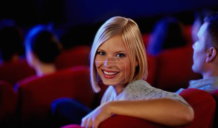 Photo for Cinema, portrait and happy woman, watching film with smile on romantic date together. Movie night, face of girl in theater with man at box office show and sitting in auditorium to relax at premier - Royalty Free Image