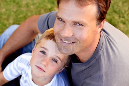 Photo for Smile, portrait and dad with son on grass, cute bonding together with care and love in backyard from above. Fun, father and child in garden with happy relationship, trust and support with man and boy. - Royalty Free Image