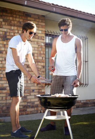 Photo for Men, grill and meat season for BBQ in the backyard with cooking and lunch with friends. Garden, food and chat outdoor with young people together ready for eating with barbecue lunch in a yard. - Royalty Free Image
