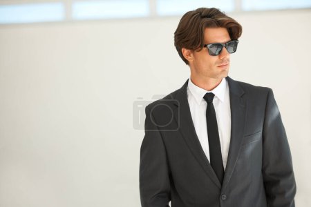Photo for Confidence, attitude and business man in office with glasses, attitude or empowered on wall background. Leader, mindset and cool male entrepreneur thinking, edgy and posing with leadership or focus. - Royalty Free Image
