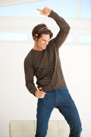 Photo for Dance, headphones and man with phone in home to celebrate freedom, enjoy happy subscription and hearing digital audio. Excited guy listening to music, radio and sound on mobile smartphone with energy. - Royalty Free Image