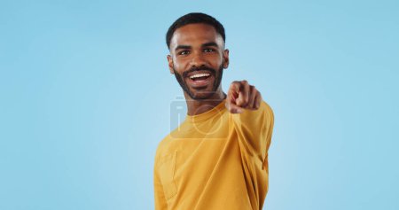 Photo for Face and man with hand pointing at you in studio with choice, selection or offer on blue background. Opportunity, offer and portrait of male model with emoji for join us, deal or invitation. - Royalty Free Image