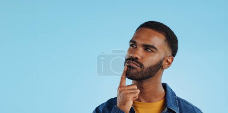Photo for Man, thinking and planning idea with decision and choice in studio on blue background and questions. Brainstorming, person and problem solving ideas or why with solution and remember on mock up space. - Royalty Free Image