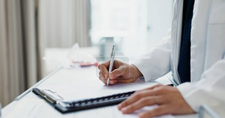 Photo for Doctor, hands and writing on checklist at desk for health, information and paperwork. Table, clipboard and closeup of medical woman on chart for prescription, notes or insurance document in hospital. - Royalty Free Image