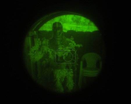 Photo for Night vision, soldier or sniper scope in military for aim, target or firearm with mission or battle. Man, person or camouflage for battlefield, service and defense with army, bootcamp and incognito. - Royalty Free Image