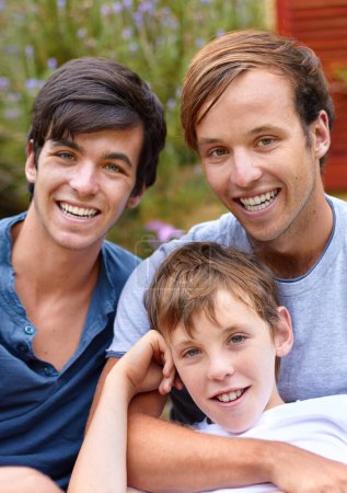Photo for Portrait, men or brothers in backyard with smile, hug and bonding in garden of home or house outdoor. Family, people or child together with happiness and embrace for relax, peace or relationship. - Royalty Free Image
