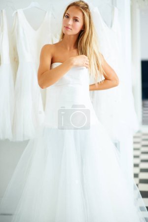 Photo for Wedding, beauty and portrait of young bride shopping for dress in boutique, shop or store in mall for fitting. Retail, romance and female person from Canada preparing for marriage ceremony or party - Royalty Free Image