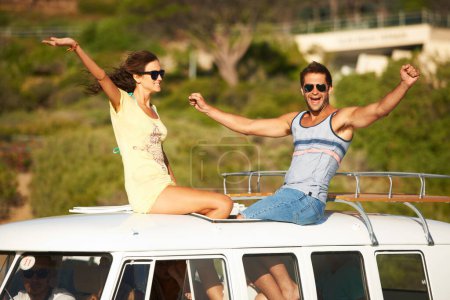 Photo for Excited, travel or happy couple on road trip for holiday or fun summer vacation together to relax. Woman, man or people on roof of van on break or journey adventure for freedom with hands up or smile. - Royalty Free Image