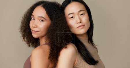 Photo for Women, friends and face for skincare, beauty or cosmetics with diversity on a brown studio background. Young model or people in portrait together for skin care, dermatology health and natural makeup. - Royalty Free Image