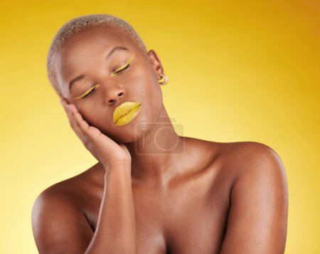 Photo for Creative, makeup and face with lipstick or black woman in studio on a yellow background for art, beauty or cosmetics. Gold, color and eyeshadow on calm model sleeping with unique aesthetic or art. - Royalty Free Image