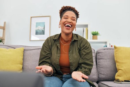 Photo for Comic, happy or funny with a black woman laughing while sitting on a sofa in the living room of her home. Comedy, smile and freedom with a carefree young female person joking eyes closed in her house. - Royalty Free Image