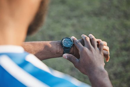 Photo for Hands, man or soccer player with smart watch on field to monitor time, training or exercise progress. Wellness, performance or healthy sports athlete with timer to check running workout or fitness. - Royalty Free Image