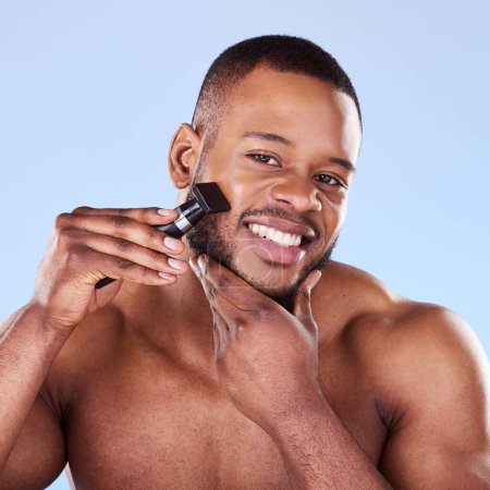 Photo for Portrait, man and shave with razor for hair removal, aesthetic skincare and facial cleaning in studio. Happy black male model shaving beard on face with blade, trimmer and cosmetic tool on background. - Royalty Free Image