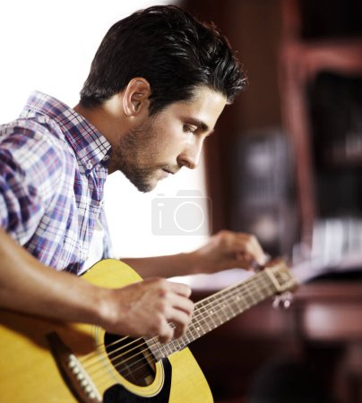 Photo for Guitar, tuning or man in house for music, performance or entertainment in living room with talent. Learning solo, acoustic strings or creative musician playing an instrument for artistic expression. - Royalty Free Image
