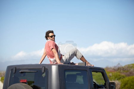 Photo for Road trip, man and roof of car for view, scenery, nature and fresh air on adventure or vacation in Africa. Person, tourist or traveler on rooftop with sunglasses and sky mockup for peace or journey. - Royalty Free Image