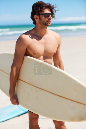 Photo for Summer, travel and a man surfer on the beach for surf, freedom or adventure on vacation. Nature, sand and a young person shirtless with a surfboard by the ocean or sea on a tropical coast for holiday. - Royalty Free Image