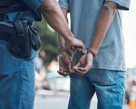 Photo for Handcuffs, police and hands of police man with criminal in city for justice, crime or corruption. Illegal, arrest and law enforcement officer with suspect, thief or gangster for jail, robbery or fail. - Royalty Free Image