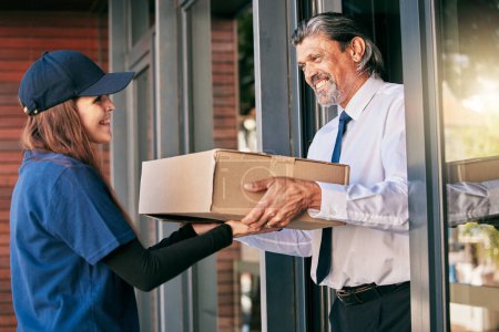 Photo for Delivery, box and business man at front door for package, ecommerce and supply chain. Shipping, cargo and logistics with courier woman and customer for exchange, distribution and mail postage. - Royalty Free Image