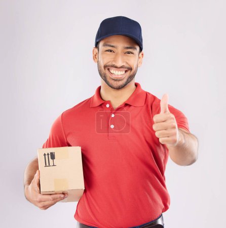 Photo for Courier man, thumbs up and studio portrait with box, delivery company and smile by white background. Supply chain manager, happy and review with icon, emoji or sign language with cardboard package. - Royalty Free Image