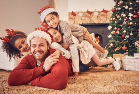 Photo for Christmas, portrait and happy family in home on floor, bonding and together. Xmas, smile and face of parents with children, interracial and African mom with father for party, celebration or holiday. - Royalty Free Image