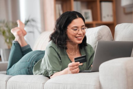 Photo for Credit card, computer and woman for home online shopping, e learning and fintech payment on sofa. Relax, student loan and person on laptop banking, study subscription or website transaction on couch. - Royalty Free Image