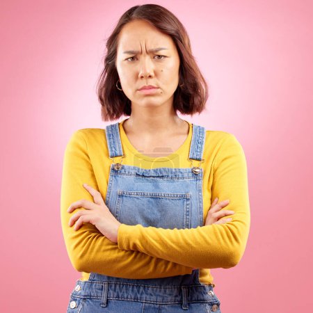 Photo for Portrait, frown and angry asian woman with arms crossed in studio and defensive body language on pink background. Wtf, face and frustrated Japanese female disappointed by news, fail or mood isolated. - Royalty Free Image